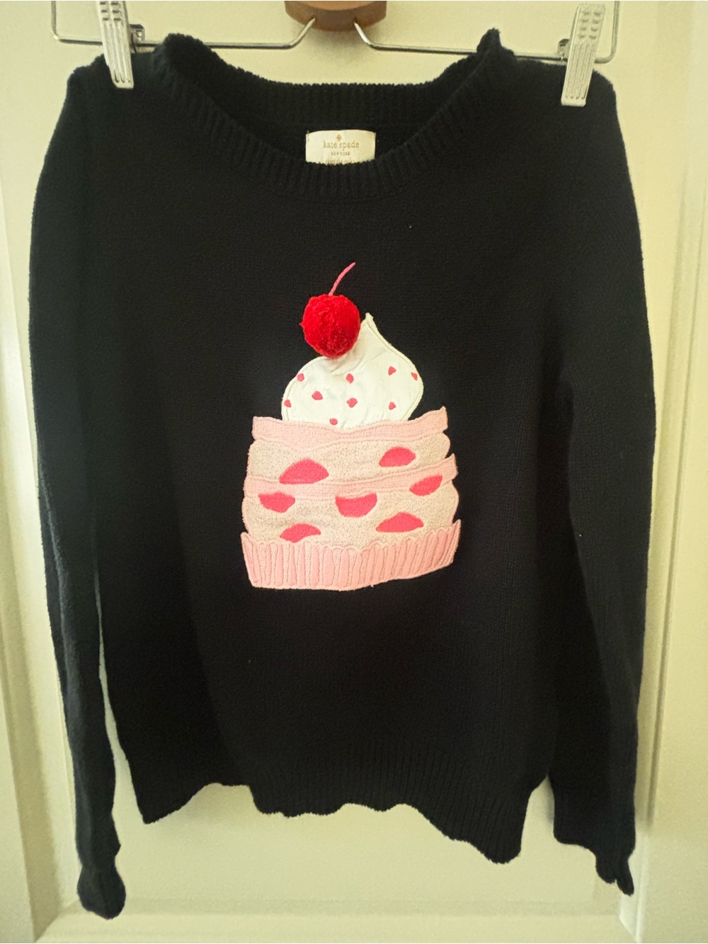 kate spade black sweater with pink cupcake and red pom detail